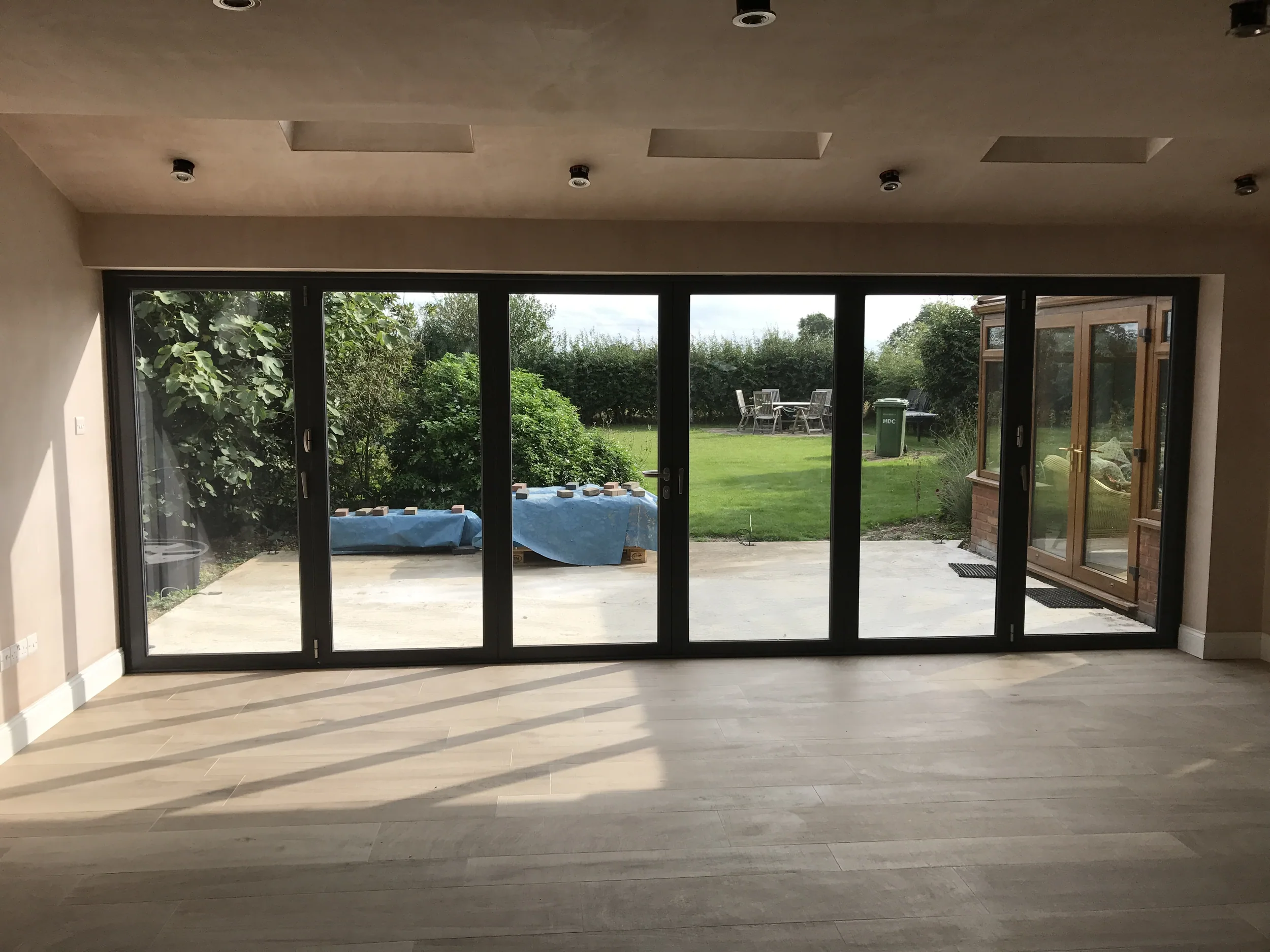Inside a finished Ablewood extension, looking out through bi-fold doors